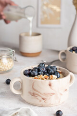 Obraz na płótnie Canvas Morning breakfast with oatmeal porridge and blueberries