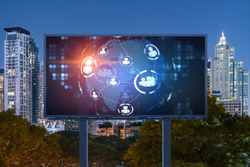 World planet Earth map hologram and social media icons on billboard over night panoramic city view of Bangkok, Southeast Asia. Networking and establishing new connections between people. Globe