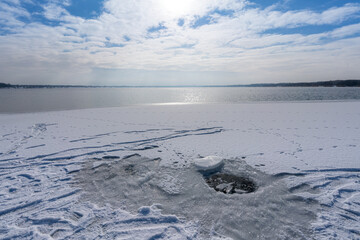 Ice hole in a frozen lake