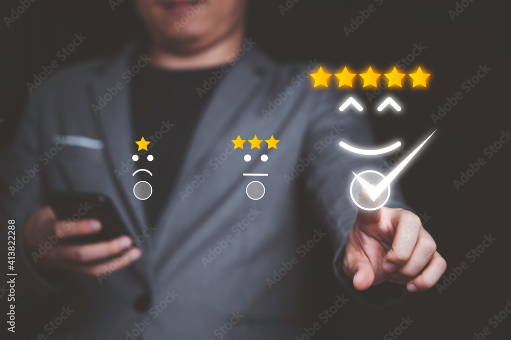 Poster businessman using smartphone and pushing smile button for the best evaluation , customer satisfactio