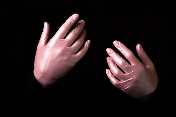 Hands emerging from the darkness. Pantomime with rubber gloves. Spot lighting. Magician.
