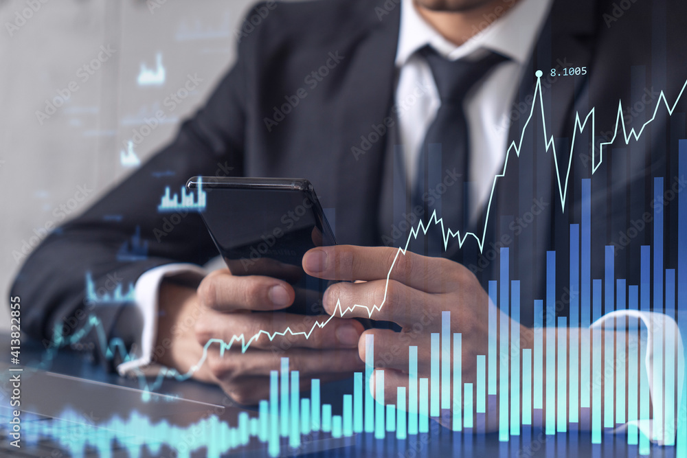 Poster Trader holding in the hands a smart phone and researching stock market to proceed right investment solutions. Internet trading and wealth management concept. Hologram Forex chart over close up shot.