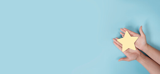 woman hands holding yellow star