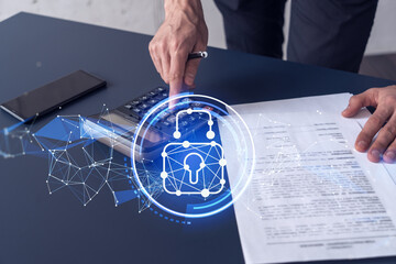 A businessman computing probability of risks in cyber security protection using calculator. Padlock Hologram icons over the working desk. Formal wear.
