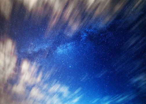 Milky Way framed by moving clouds