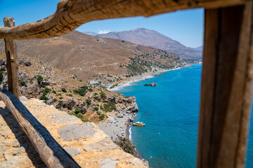 Famous Preveli palm beach on Crete island, Greece. Wooden barriers in foreground 