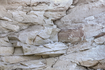Grungy stone rocky slate facade of worn mining quarry. Uneven strong caving chipped granite slices of shabby boulder edge blocks. Rustic hewn bumpy grunge of vintage big bold cliff for 3D rough design