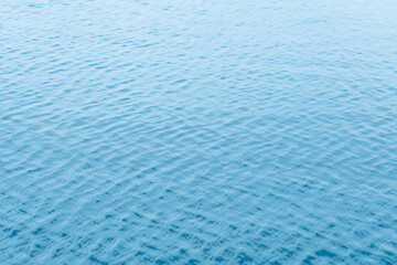 Water surface of swimming pool with sun reflection