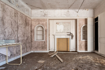 Room in disrepair with black mould and pinkish tinges