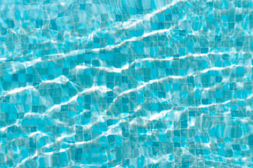 Water surface of swimming pool with sun reflection