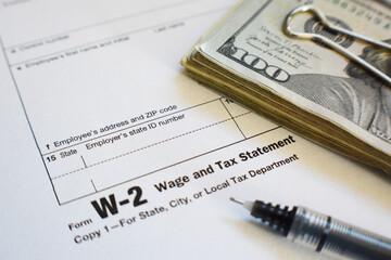 W-2 Tax Form With Fine Point Pen And Money Close Up High Quality 