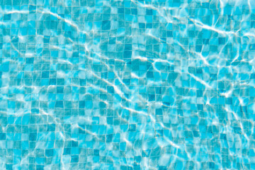 Water surface of swimming pool with sun reflection