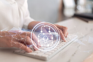 A woman programmer is typing a code on computer to protect a cyber security from hacker attacks and save clients confidential data. Padlock Hologram icons over the typing hands. Formal wear.