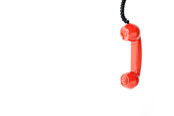 Classic red phone on white background.