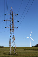 High voltage power line against the background of a wind turbine