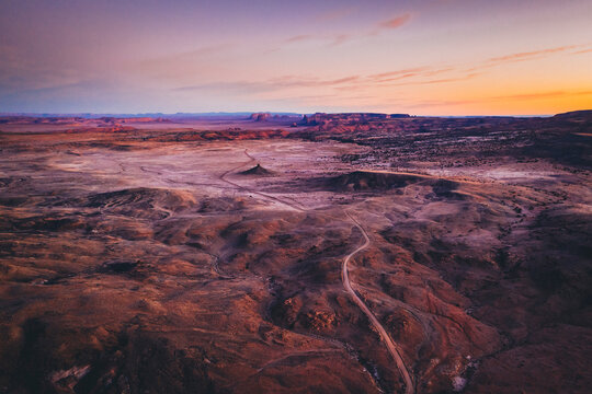 Aerial view of an unpaved road in a Arizona desert in the morning