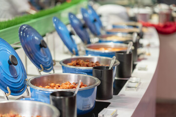 buffet food with blue heated trays