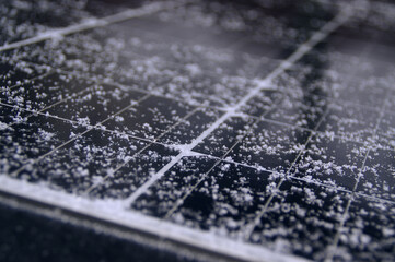 Snow on solar panels. Electricity production from the sun and photovoltaic in winter.