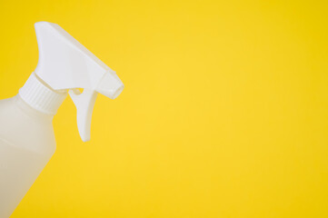 Closeup shot of a white plastic spray bottle isolated on yellow background