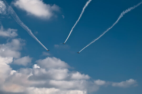 Military aircraft squadron flies into the distance in blue skies
