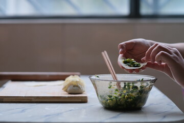 close up hand making dumpling. Traditional Chinese food during Chinese new year. Chinese culture concept