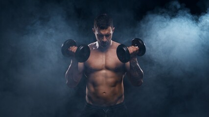 Fit and sporty bodybuilder over black background. Sportsman in studio. Sport and fitness concepts.