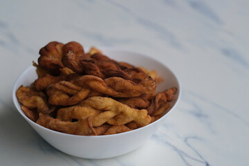 close up deep-fried dough twist on table. Traditional Chinese snack