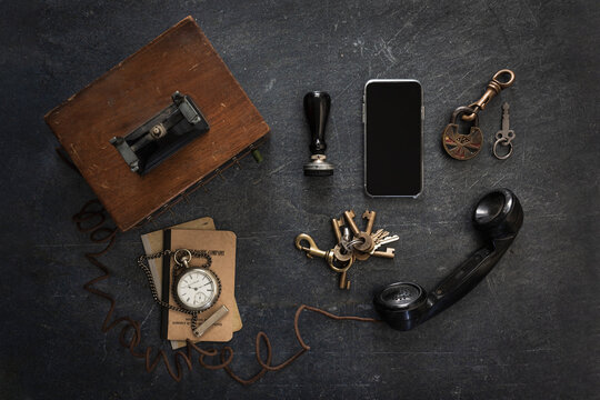 different means of vintage communication surrounding a cell phone