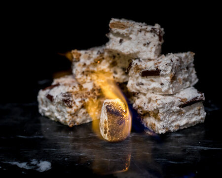 Homemade S'mores Marshmallows Behind a Flaming Marshmallow