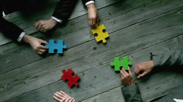 Business teamwork with color puzzle of four pieces cooperation unity concept