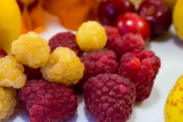 Yellow and red raspberries close-up.
