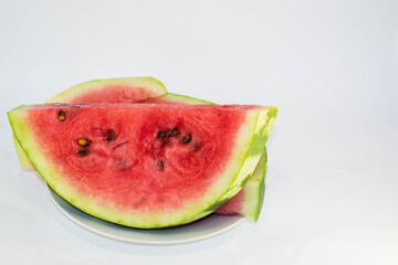 Ripe watermelon on a light background.