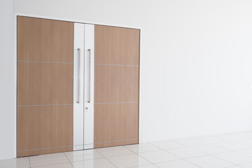 Modern wooden door and empty white wall , which ideal for use in the background design  put images and insert text