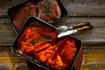 pieces of meat in packing on a wooden background