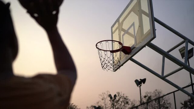 Basketball player training shooting at the local court
