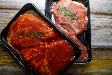 pieces of meat in packing on a wooden background