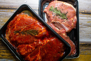 pieces of meat in packing on a wooden background