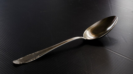 table metal spoon on black surface 