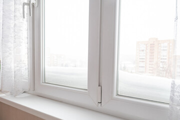 Thick layer of snow outside window after heavy snowfall in winter