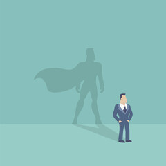 Businessman and shadow in the form of a hero with a cloak.