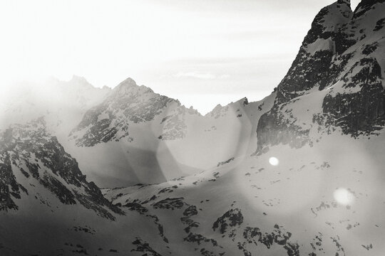 snow cliff and rock in the mountains make a contrasty b&w sunset