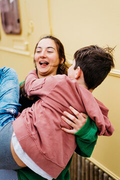 Brothers enjoying outdoors in sunny day, girl  holding in arms boy