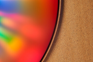 Sandstone background, reflective disk with beautiful colors. Selective focus. front view.
