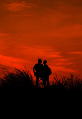 silhouette of a couple against the background of the evening sky