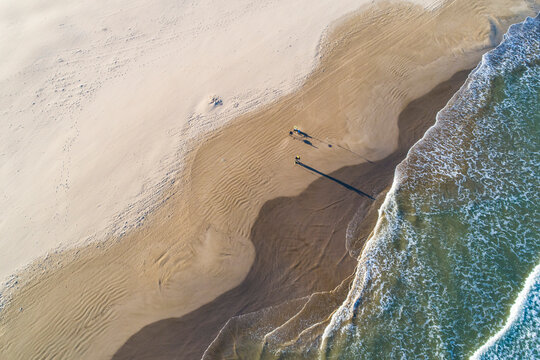 Aerial abstract view of Valencia beach with waves and wet sand