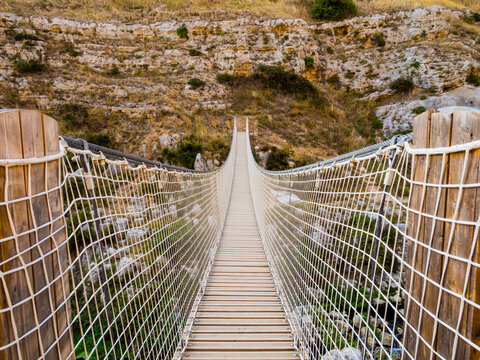 Fototapeta Impressive hanging bridge over Gravina canyon in Murgia National Park, Matera, Italy 