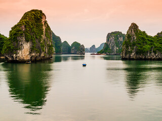 Stunning view of Halong Bay karst formations reflected in the emerald waters of Tonkin gulf, Vietnam
