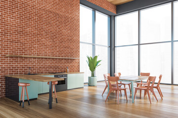 A corner of modern kitchen interior with copy space on brick wall, wooden countertops with a built in sink and a cooker. mock up. Loft apartment with dining area.