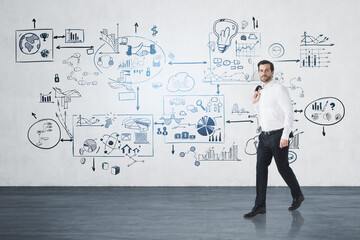 Fototapeta premium Businessman in white shirt holding his jacket walking along the