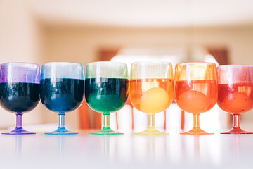 Rainbow array of cups with Easter egg dyes